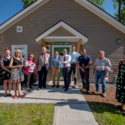 Photo of TPH Staff in front of the community building