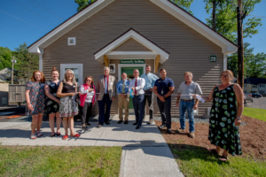 Photo of TPH Staff in front of the community building