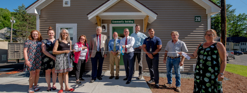 Photo of TPH Staff in front of the community building